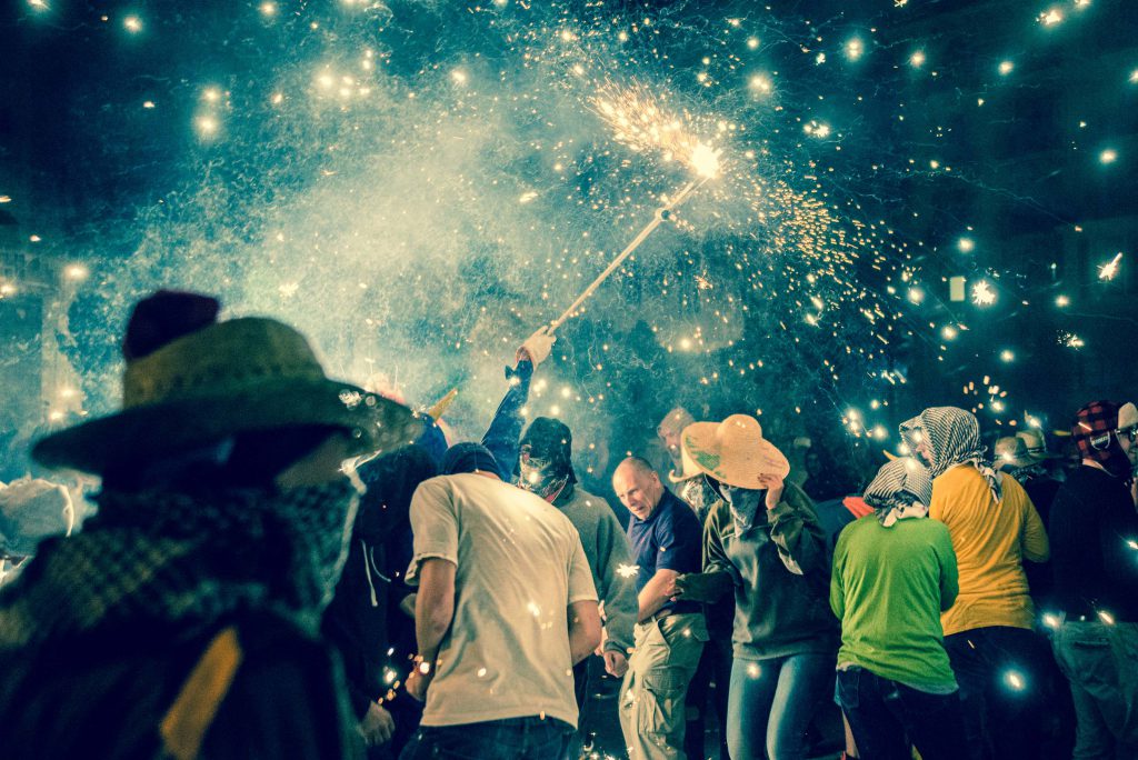 People running around a gunpowder umbrella.