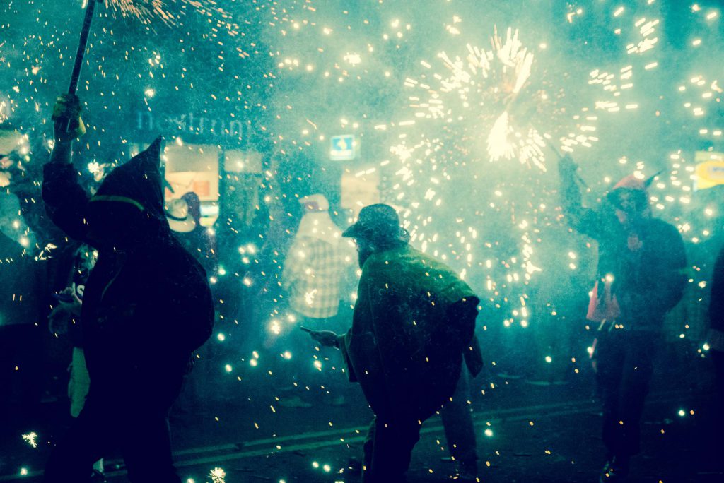People running under a gunpowder umbrella.